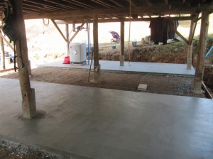 This is the what the partly finished job looks like now. You can see my shiny new washing machine at the far side. When it is finished, we will use under the house for laundry, parking motor bikes, and for an extra classroom. 